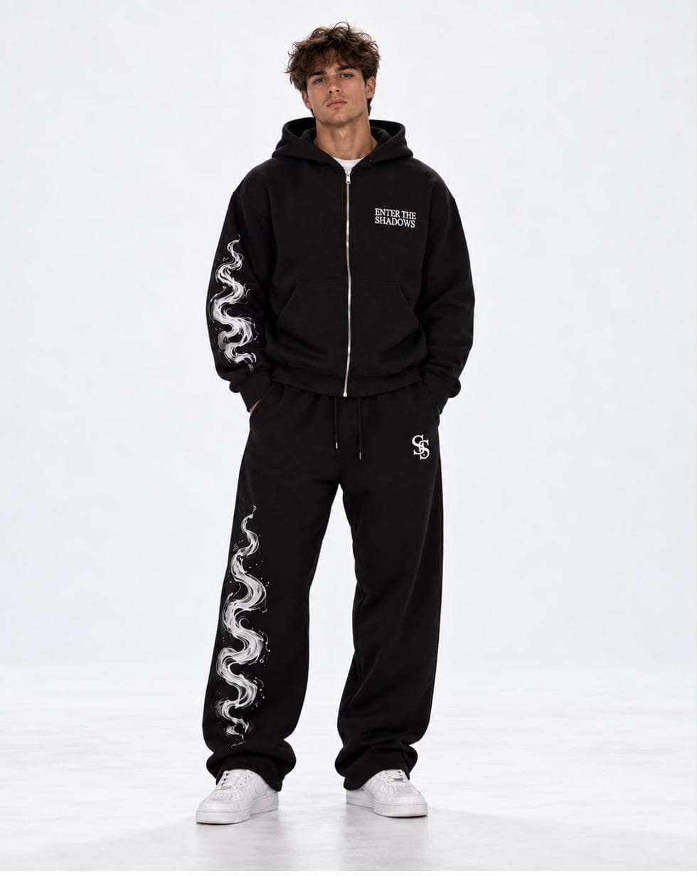 Model in the black zip hoodie and black joggers
