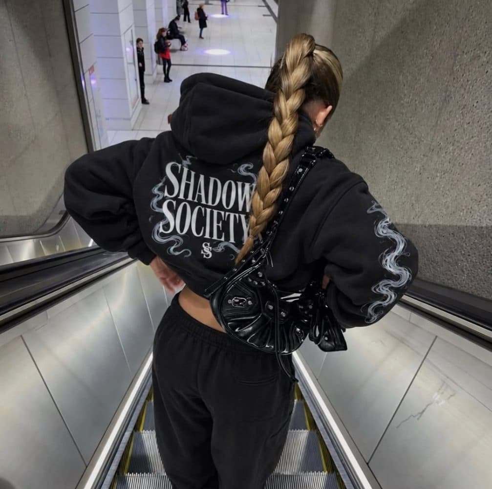 Black hoodie back print on an escalator